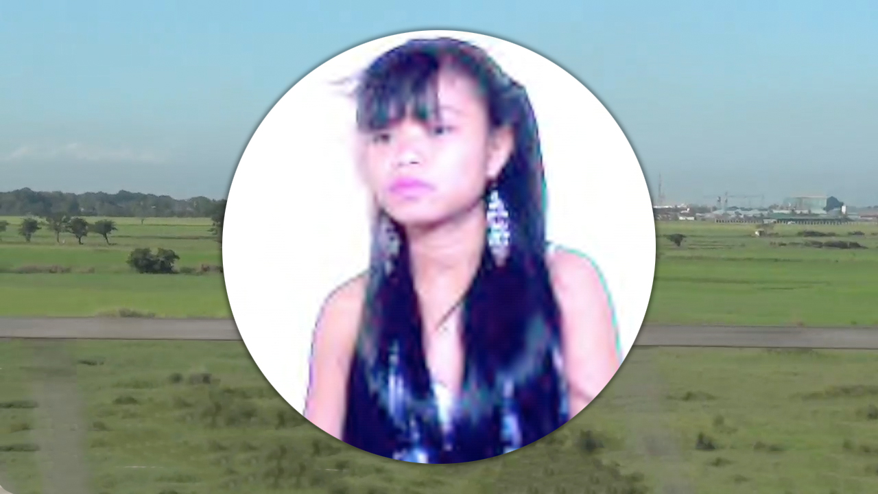 Asian In Pigtails over background of field in Manila