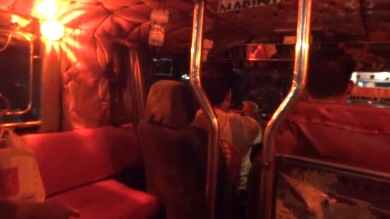 View inside Philippine Jeepney at night with red lighting inside