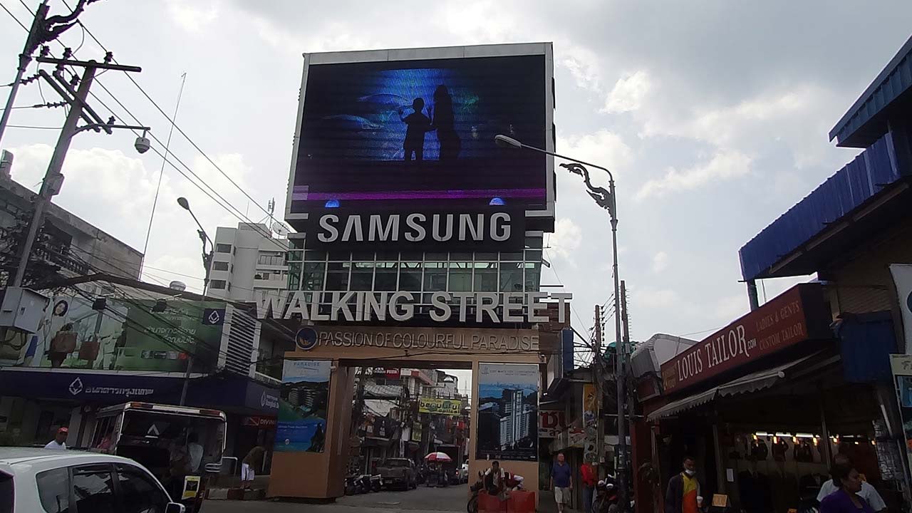View of Samsung sign and Walking Street from back of Motorcycle Taxi