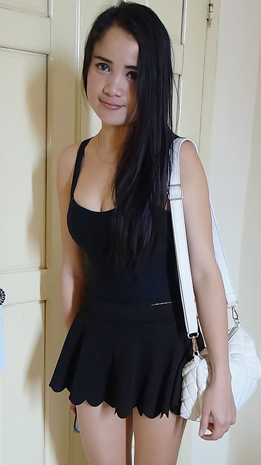 Asian Sex Diary Banana holds purse and shows her short black skirt