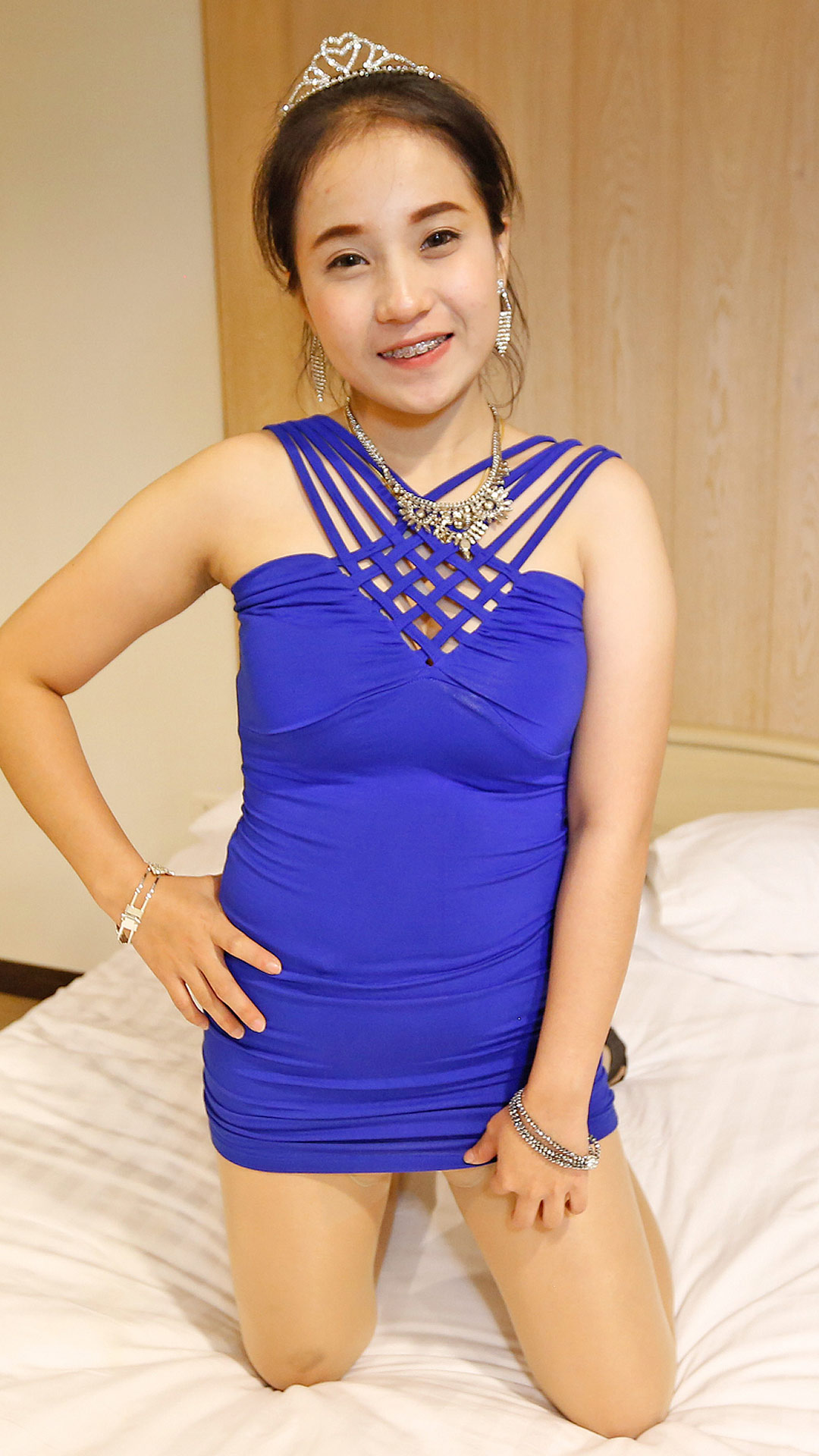 Cute Asian Sex Diary Nate poses on the bed in her blue dress