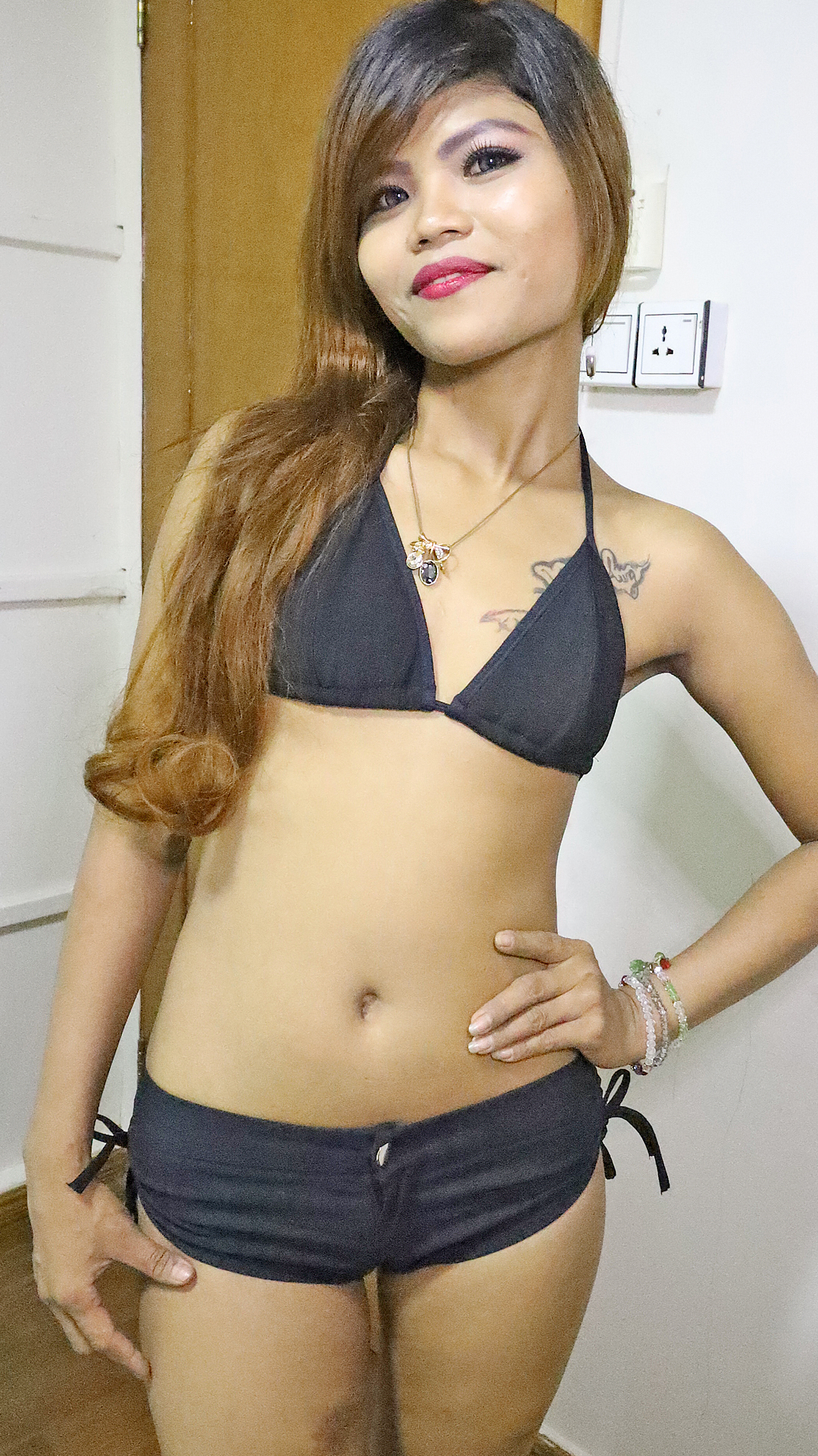 Exotic Asian Sex Diary May L standing in black swimsuit