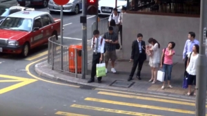 Hong Kong citizens waiting at crosswalk in Wanchai HK