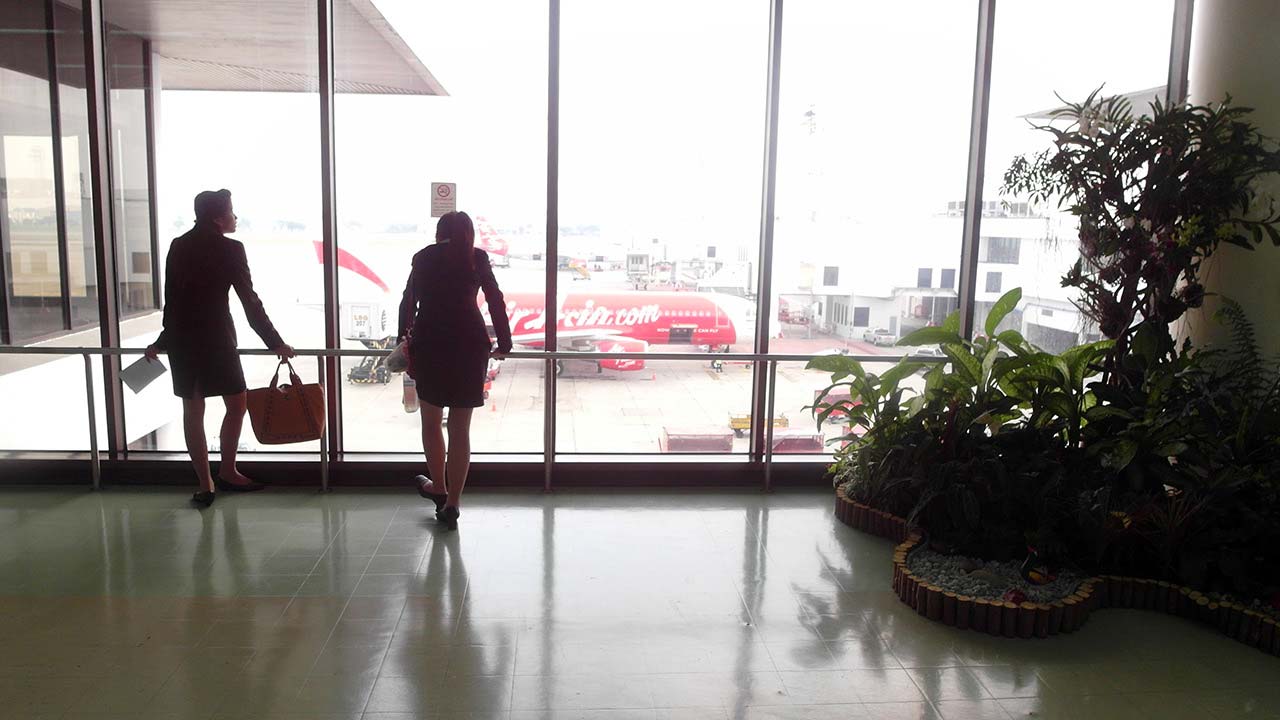 Hot Flight Attendants waiting at big window