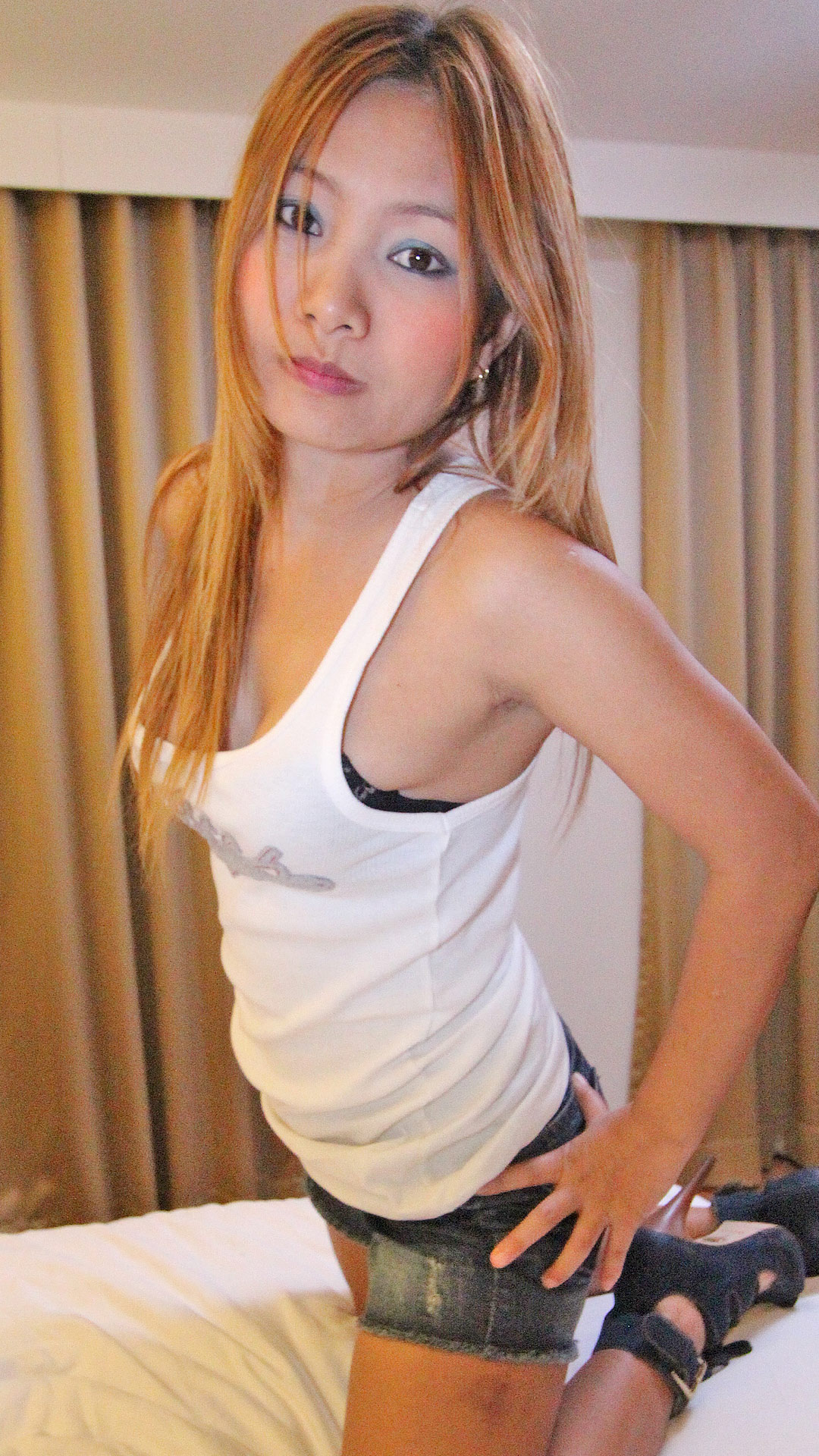 Petite Asian Sex Diary Ning on the bed in her clothes