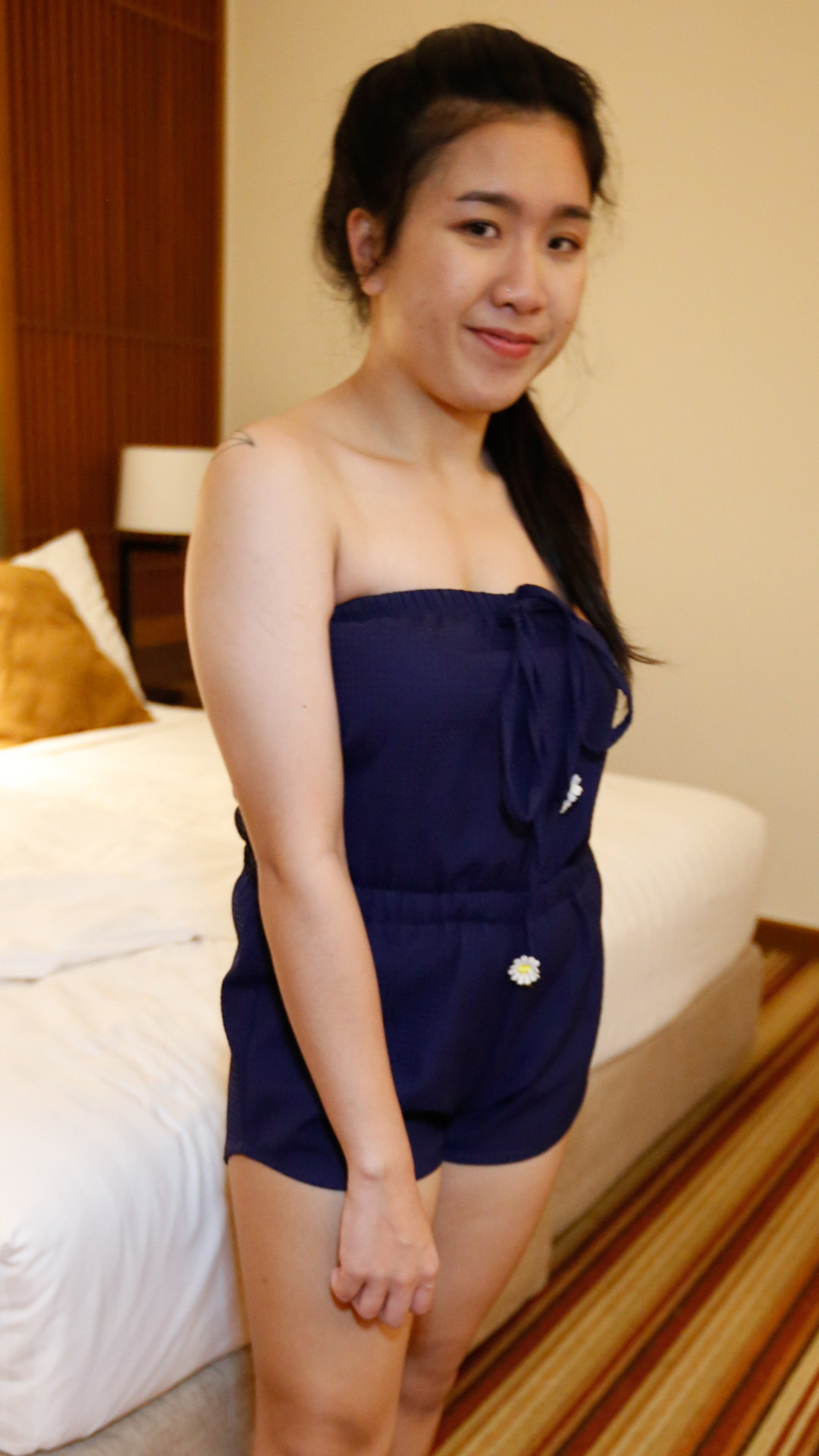 Asian Sex Diary Hnin poses next to bed for photo