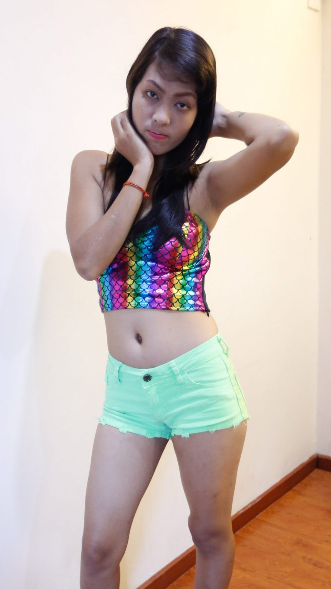Asian Sex Diary Lyn B poses near the wall