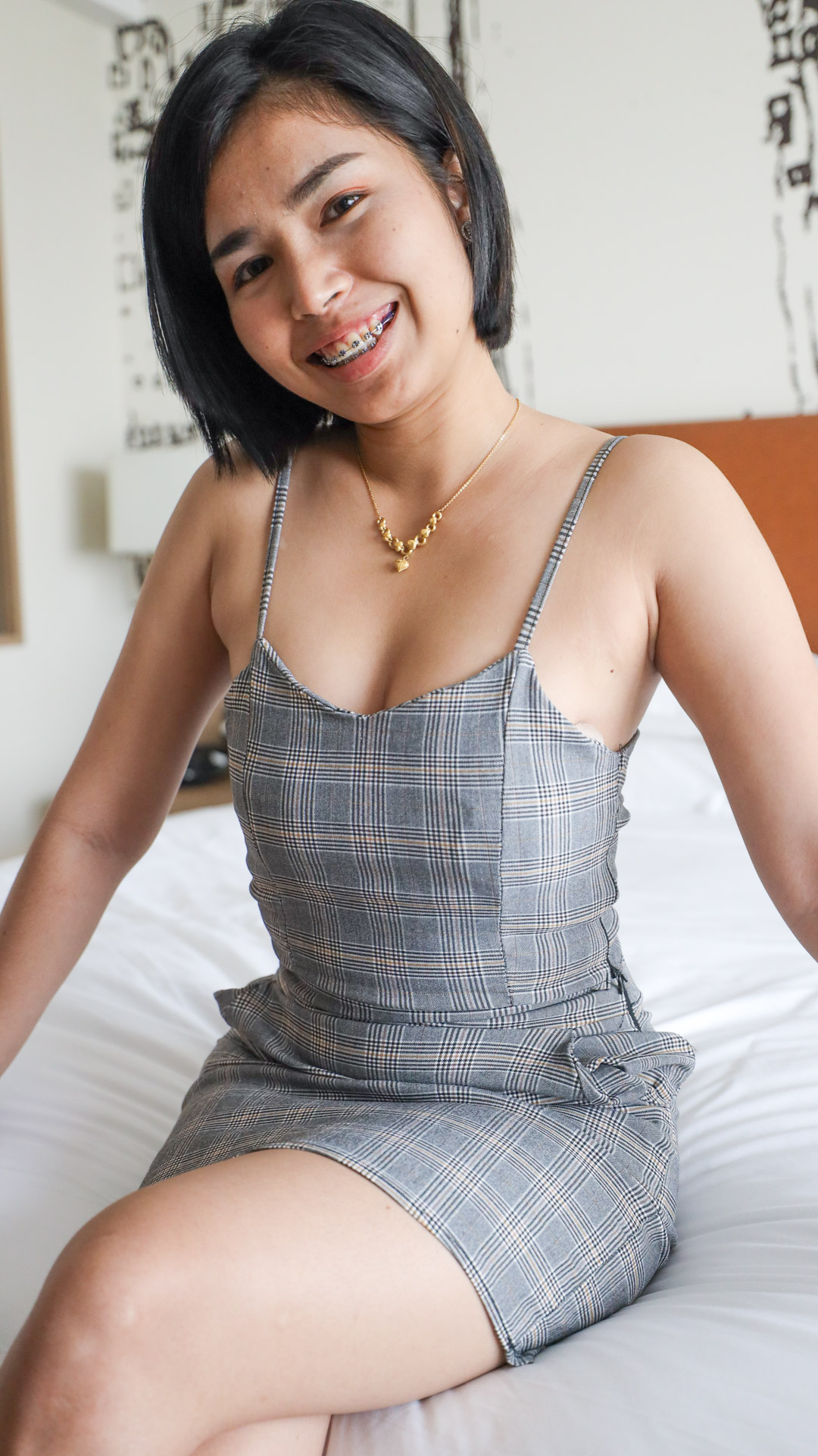 Tight body Asian Sex Diary Toei B models in tight dress on the bed showing her braces while smiling