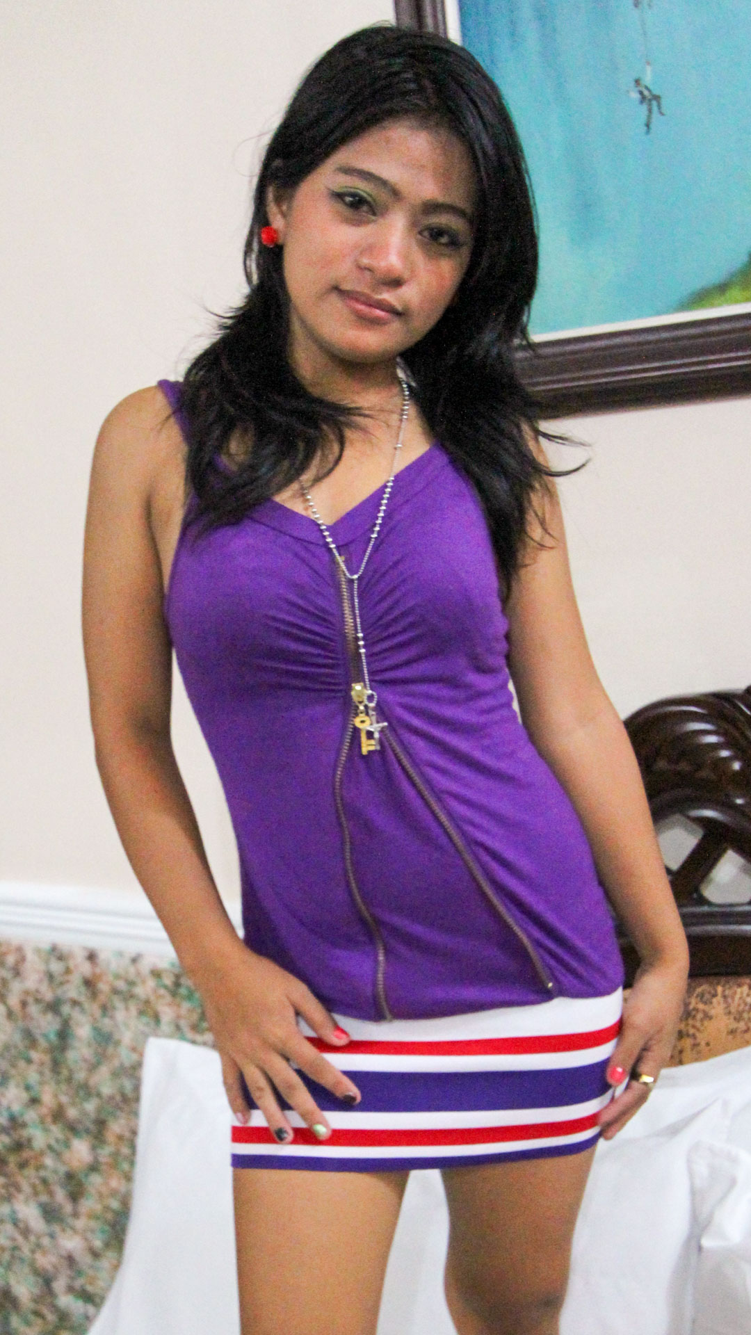 Beautiful Thai babe Asian Sex Diary Veregit shows her purple dress and striped shirt