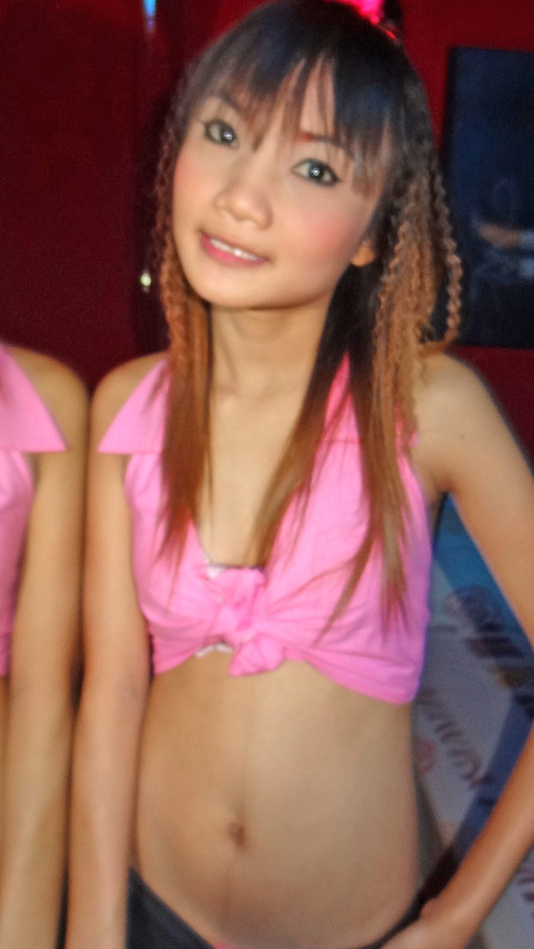 Tiny Asian Sex Diary Pim poses in her pink top at the club