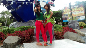 Amel and Rini posing in front of the Dufan sign