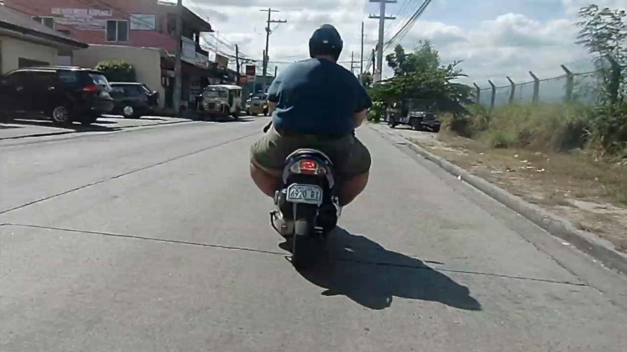 Behind view of a Fat Man On Bike