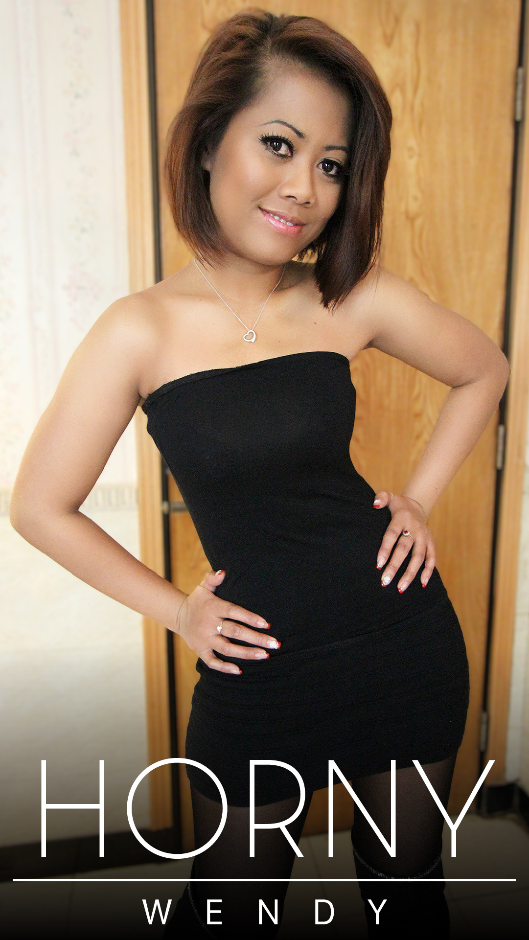 Horny Asian Sex Diary Wendy stands with hands on hips in sexy black dress