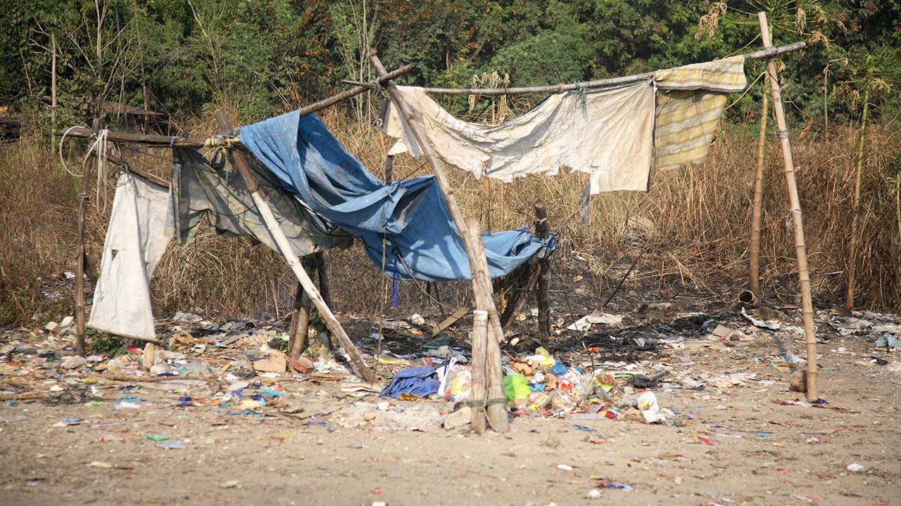 Piles of Philippines trash and a makeshift clothes drying rack