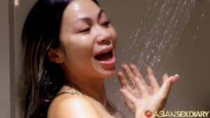 Cleaning off her Asian BJ Facial mess in the shower